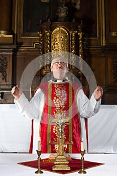 Priest praying during mass