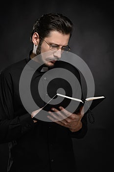 Priest reading the Holy Bible. Portrait of priest reading the Ho