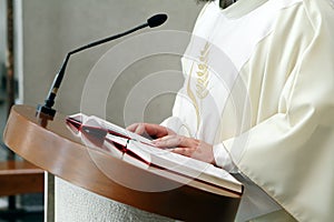 Priest reading open holly bible