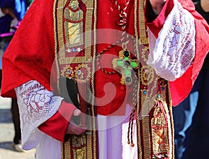 priest with religious dress during the blessing with the bible in his hand