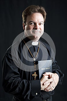 Priest With Rosary and Bible