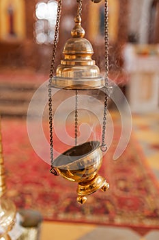 A priest`s censer hanging in the Orthodox Church. Copper incense with burning coal inside