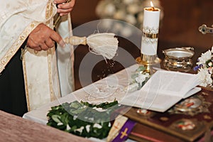 Priest sanctifies wedding rings. Table in the church