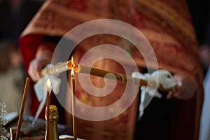 Priest sets fire to candle from another candles