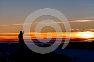 Priest silhoute reading in the sunset light, Romania