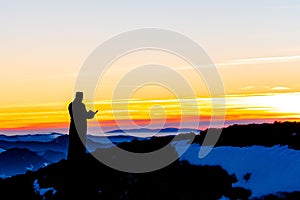 Priest silhoute reading in the sunset light, Romania