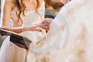 priest wears a wedding ring on bride finger