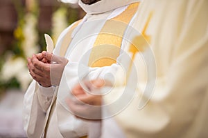 Priest` hands during a wedding ceremony/nuptial mass photo