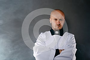 Priest in white surplice and black shirt with cleric collar photo