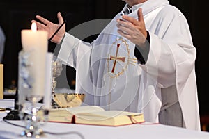 Priest and worship at the altar photo
