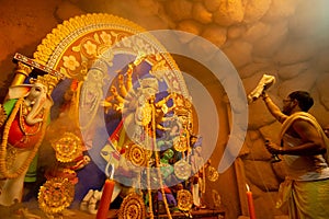 Priest worshipping Goddess Durga, Durga Puja festival celebration