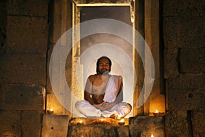 Priest or Yogi are sitting meditating in Ancient ornate huts mad