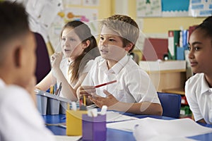 Primary school children work together in class, close up photo