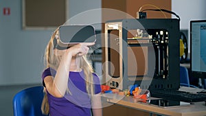 Primary school girl using virtual reality glasses exploring 3D virtual reality in school class.