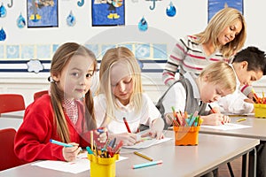 Primary Schoolchildren And Teacher Having A Lesson