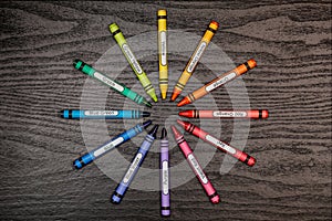 Crayons in ring on wood table