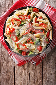 Primavera pasta with vegetables on the table. vertical top view