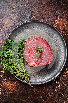 Prime Fillet Mignon Beef steak, Dry aged raw tenderloin meat. Dark background. Top view