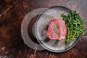 Prime Fillet Mignon Beef steak, Dry aged raw tenderloin meat. Dark background. Top view. Space for text