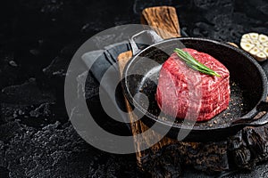 Prime Fillet Mignon Beef steak ready for cooking, Dry aged raw tenderloin meat. Black background. Top view. Space for