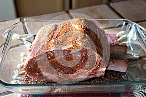A prime rib roast with dry rub on it ready to cook
