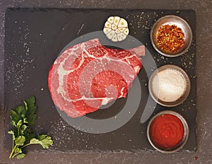 Prime rib steak on dark surface