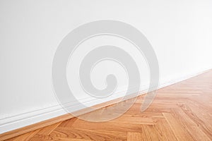 Primed white wall and wooden parquet floor - apartment interior background photo