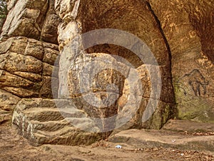 Primitive art painted on rock in sandstone cave