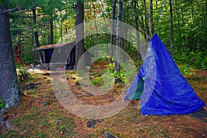 Primitive Bushcraft Campsite with a lean to and a tarp teepee in the Adirondack Mountain Wilderness.