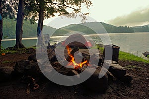 Primitive Bushcraft Campsite with a tent, chair, chair and campfire in the Adirondack Mountain Wilderness. photo
