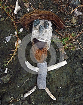 Primitive rock stone sculpture of bearded man