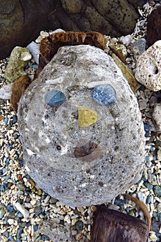 Primitive stone sculpture of a face