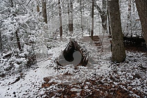 Primitive Winter Tarp Survival Shelter in the Blue Ridge Mountains near Asheville, North Carolina. Bushcraft camp setup in the