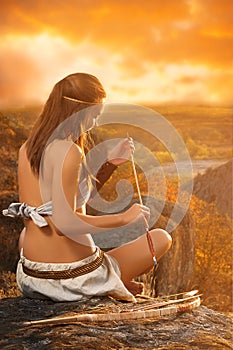Primitive woman holding a bow and arrow. Amazon woman