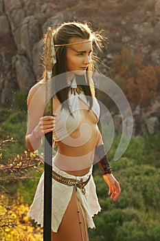 Primitive woman holding a spear. Amazon woman