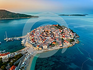 Primosten, Croatia - Aerial view of Primosten peninsula, St. George\'s Church and old town on a sunny summer morning photo
