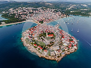 Primosten, Croatia - Aerial view of Primosten peninsula and old town on a sunny summer day in Dalmatia, Croatia with red rooftops