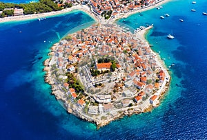 Primosten town, Croatia. View of the city from the air. Seascape with beach and old town. View from drone on the peninsula with ho