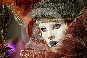 Princess with crown, blondy hair and venetian mask during venice carnival