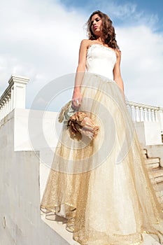 Princess in golden gown with loved toy