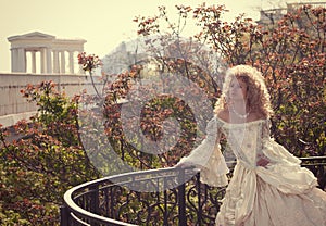 Princess leaning on railing of the balcony