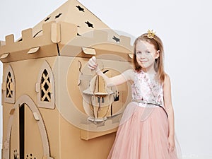 The princess play with cardboard castle tower.