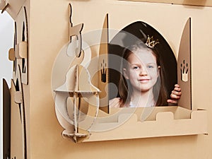 The princess play with cardboard castle tower.