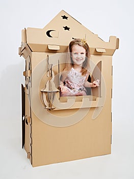 The princess play with cardboard castle tower.