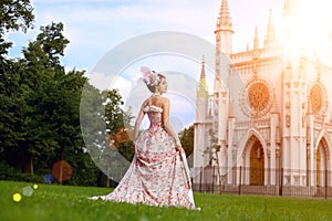 Princess in an vintage dress before the magic castle