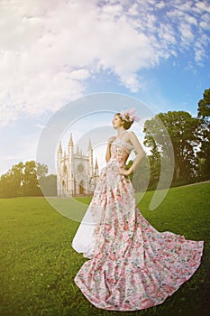 Princess in an vintage dress before the magic castle