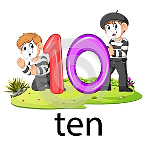 Two little pantomime playing with the 10 balloon number and text on the grass photo