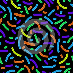 Seamless pattern of colored sprinkles in