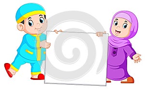 Happy moslem kid holding blank sign photo