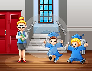 A woman teacher and cute graduation students at the hallway